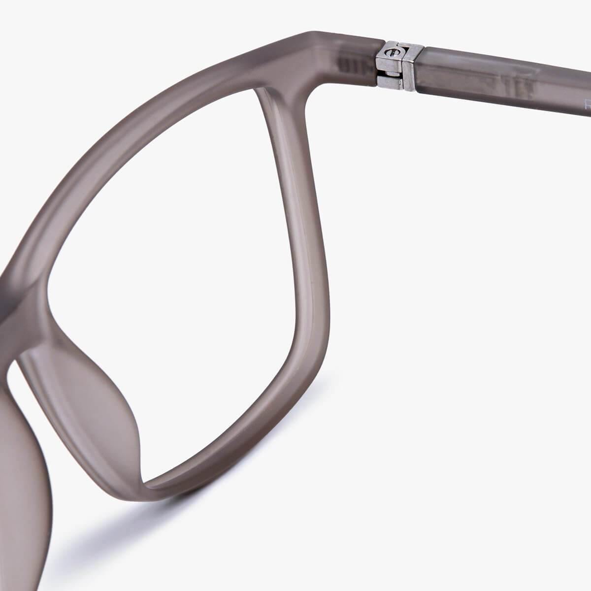Close-up of grey textured glasses frame with metal hinge