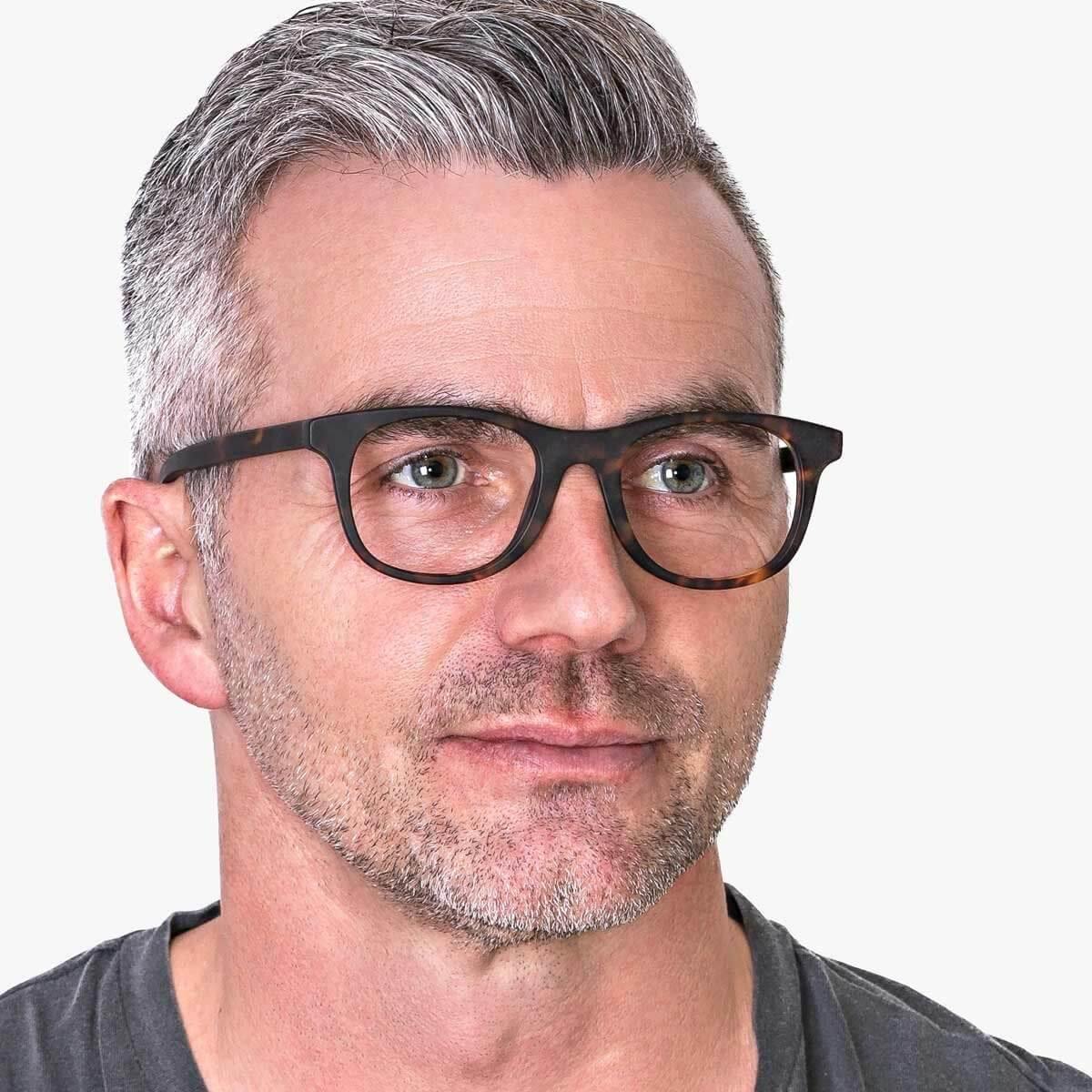 Person wearing Malmö Dark Turtle glasses with a tortoiseshell frame