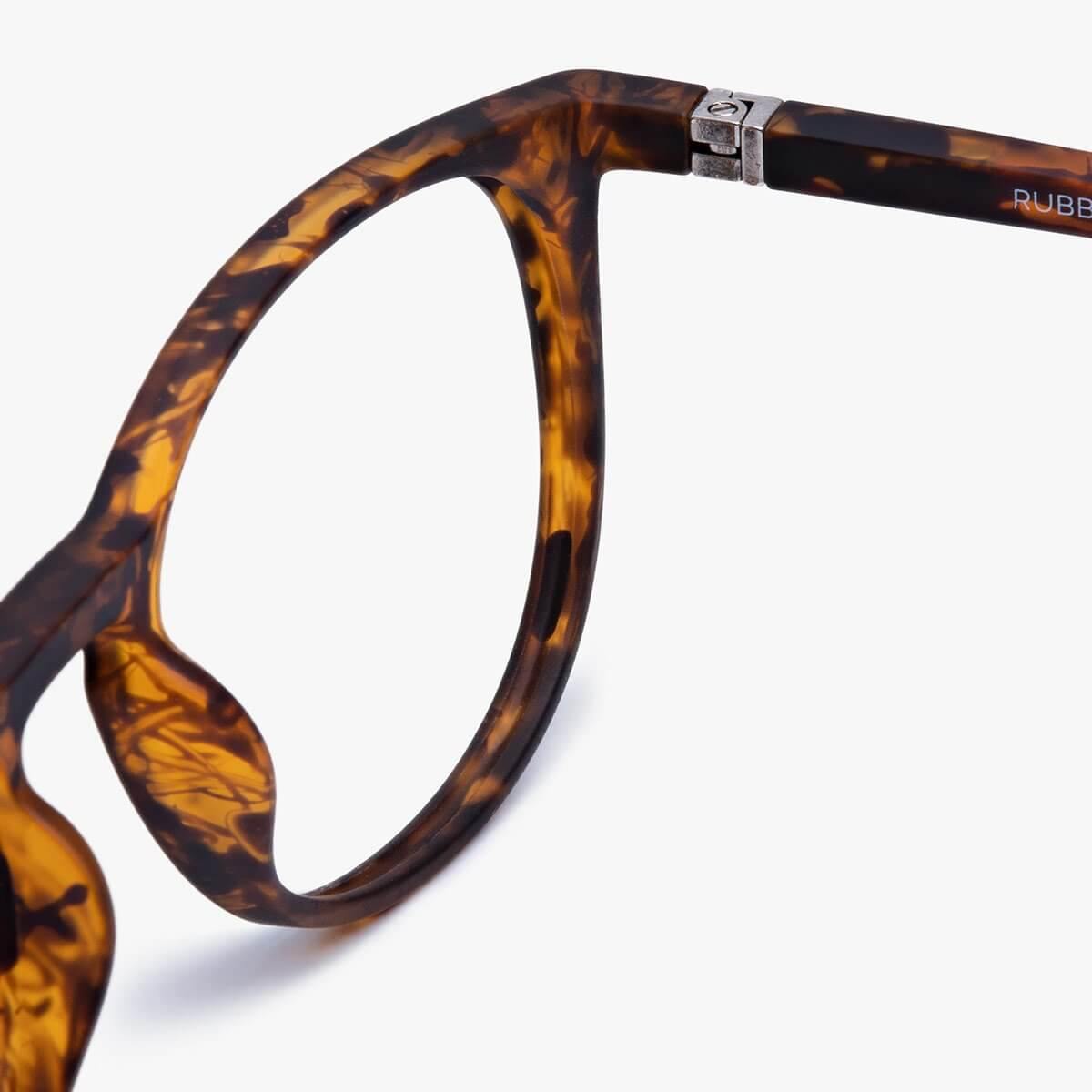 Tortoiseshell eyeglass frame with a curved temple and hinge detail