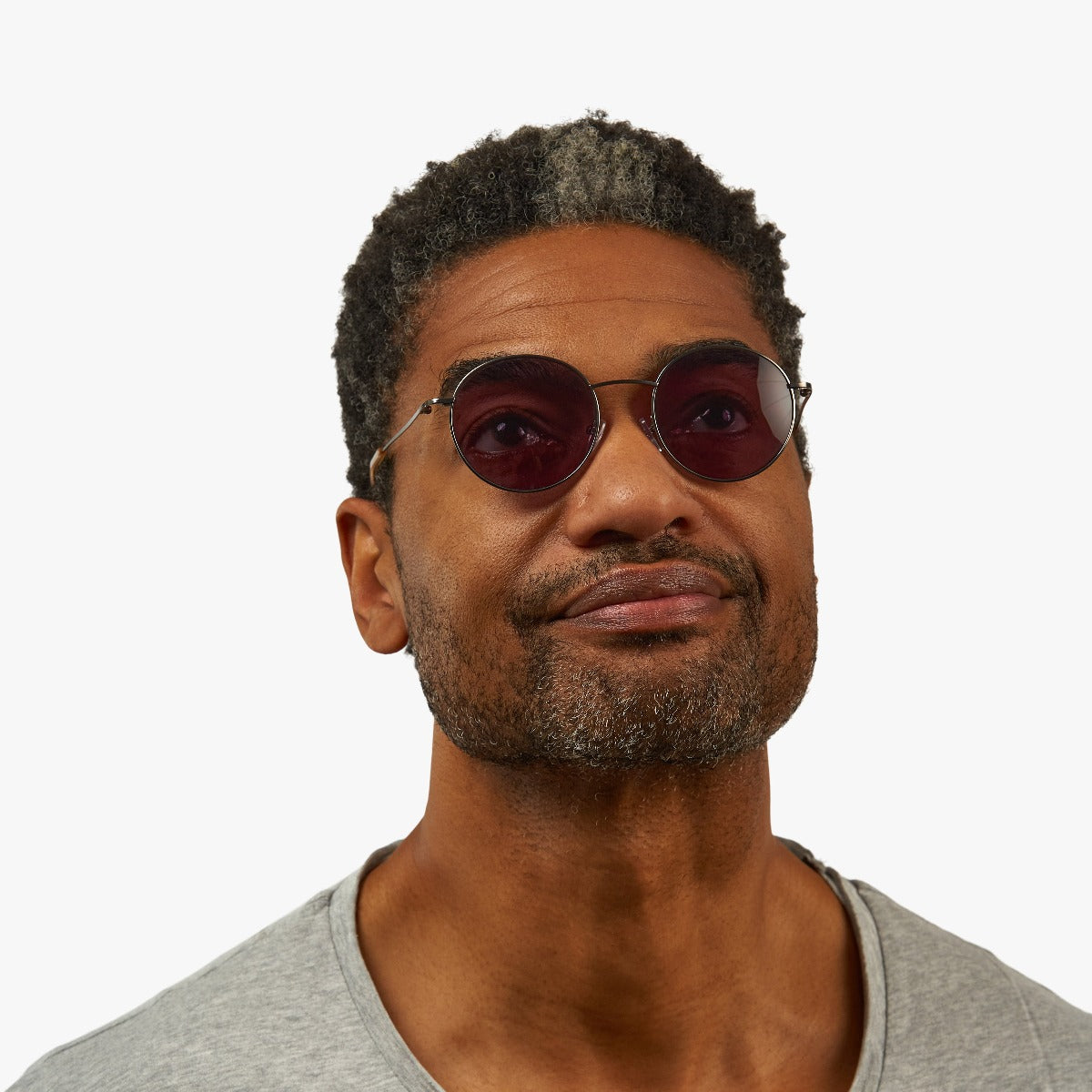 Person wearing Men's Tromsø Gun glasses with round lenses and thin metal frame