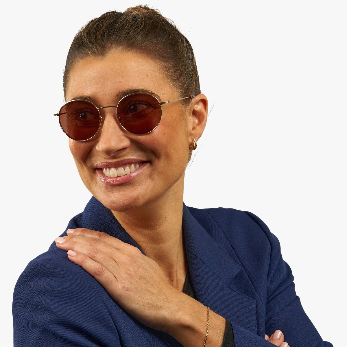 Person wearing round sunglasses with gold frames