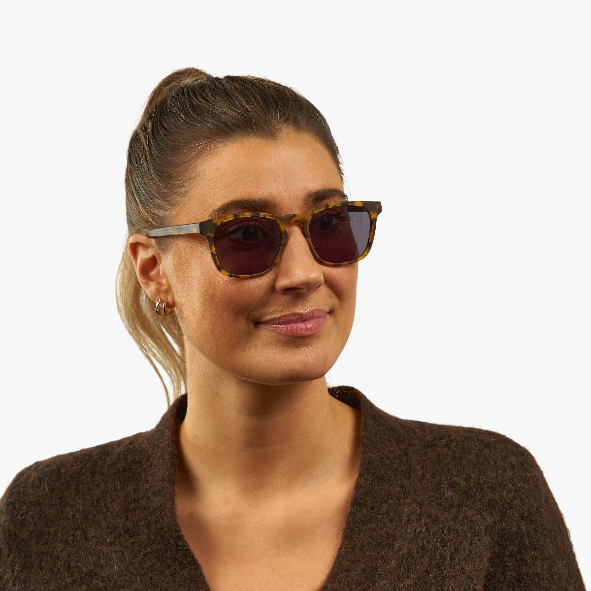Person wearing square tortoiseshell sunglasses